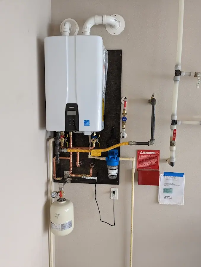 Professional plumber installing copper piping in a Victor home